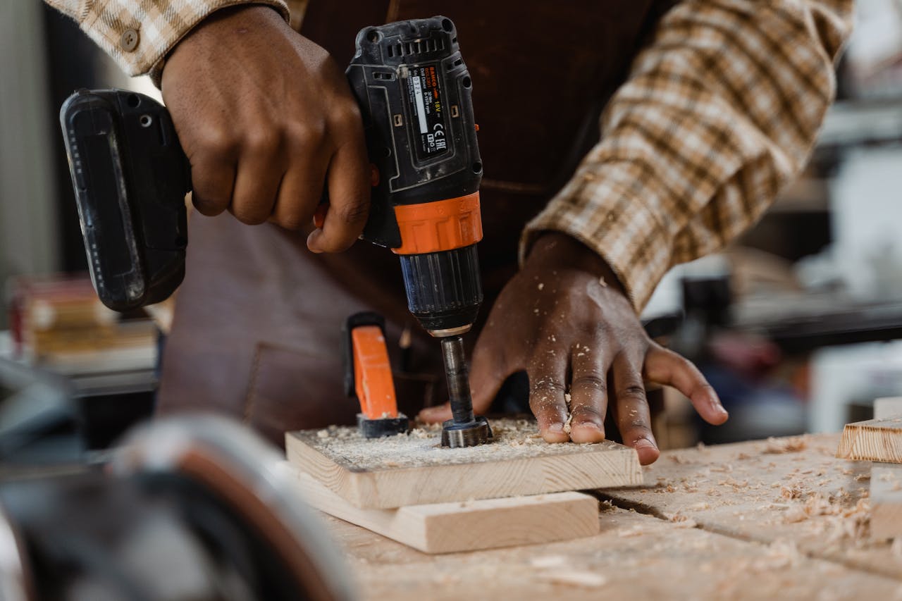 Close-Up Shot of a Carpenter Using an Impact Driver